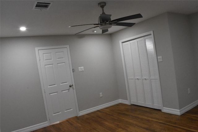 unfurnished bedroom featuring ceiling fan and dark hardwood / wood-style flooring