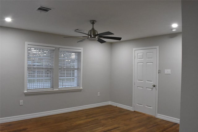 spare room with ceiling fan and dark wood-type flooring