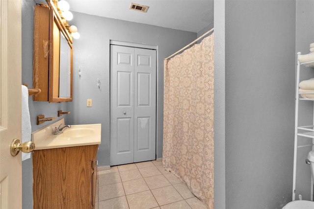 bathroom featuring tile patterned flooring and vanity