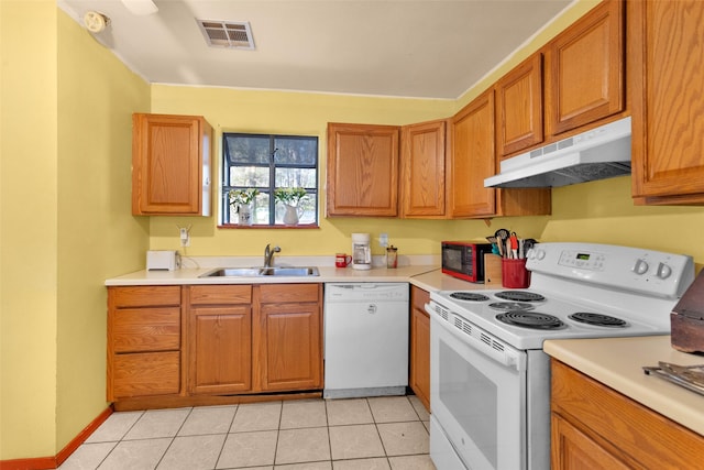 kitchen with sink, light tile patterned floors, and white appliances