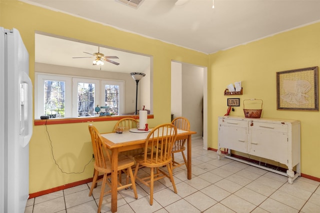 tiled dining room with ceiling fan