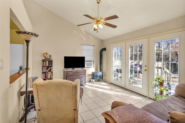 tiled living room featuring lofted ceiling, a wood stove, french doors, cooling unit, and ceiling fan