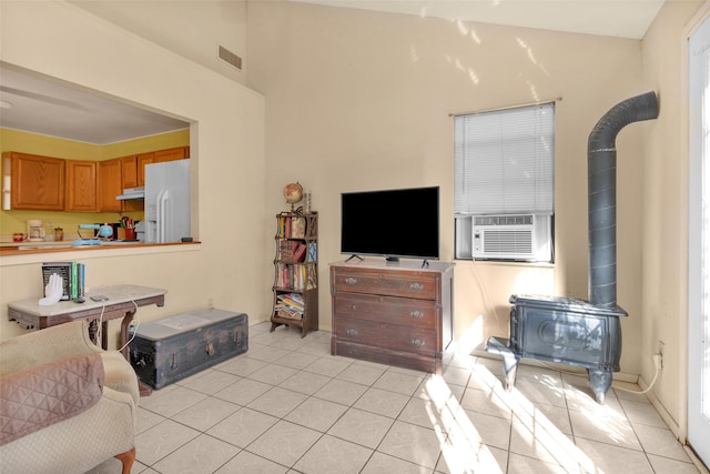 tiled living room featuring a wood stove and cooling unit