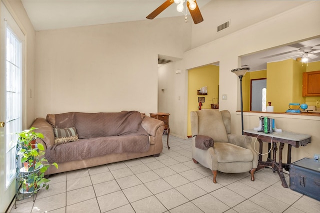 living room featuring light tile patterned floors, vaulted ceiling, and ceiling fan