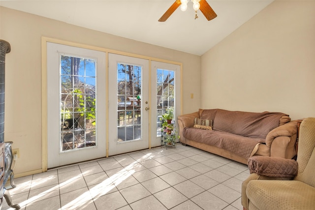 tiled living room featuring ceiling fan, french doors, and lofted ceiling