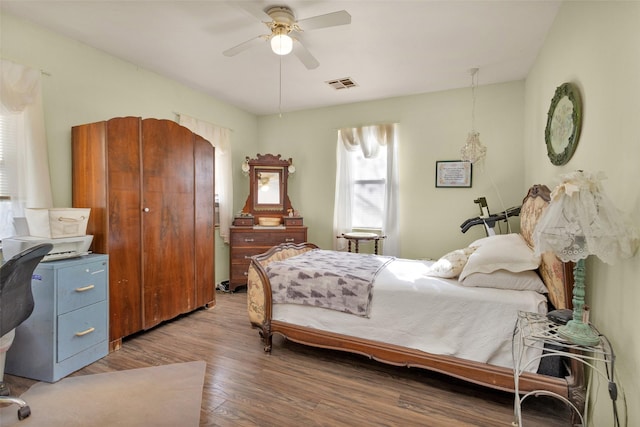 bedroom featuring dark hardwood / wood-style floors and ceiling fan