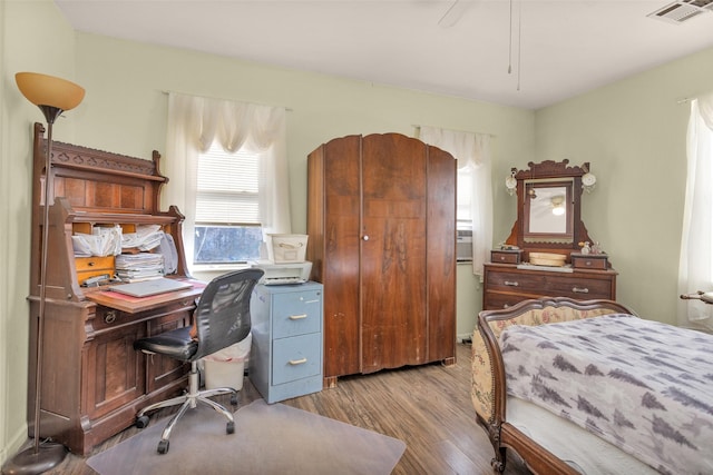 bedroom with ceiling fan and light wood-type flooring