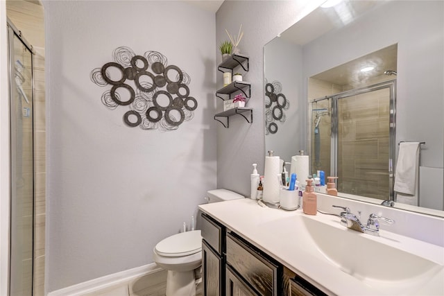 bathroom featuring vanity, an enclosed shower, and toilet