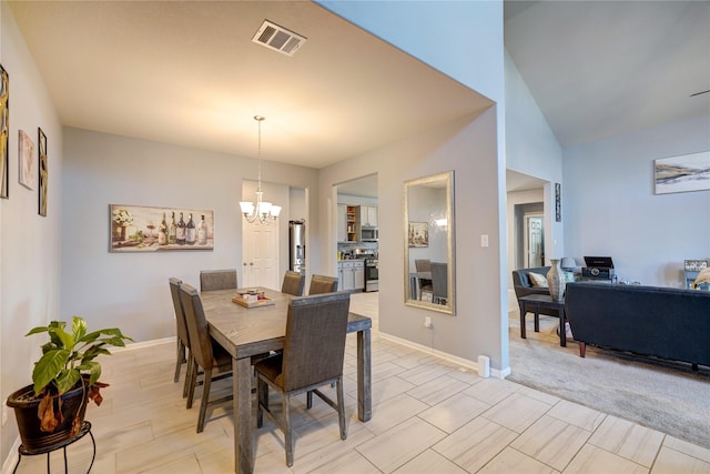 dining room with a chandelier and vaulted ceiling