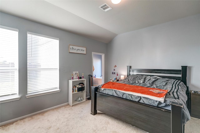 carpeted bedroom featuring vaulted ceiling and multiple windows