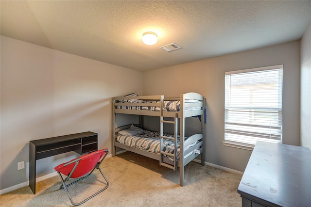 bedroom featuring carpet flooring and a textured ceiling