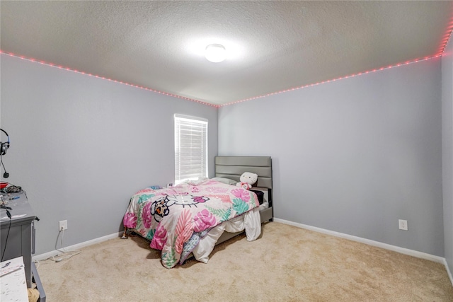 bedroom with carpet and a textured ceiling