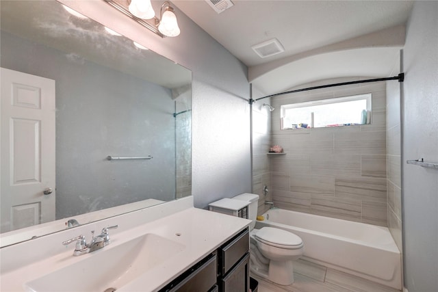 full bathroom featuring vanity, toilet, and tiled shower / bath