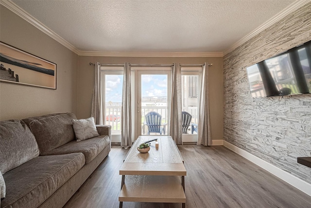 living room with crown molding, a textured ceiling, and hardwood / wood-style flooring