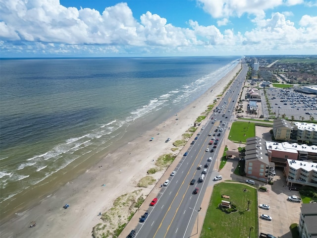 birds eye view of property featuring a beach view and a water view