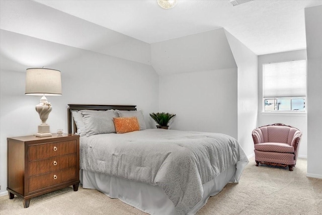 bedroom featuring light carpet and vaulted ceiling