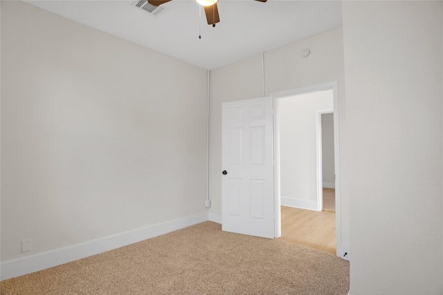 carpeted empty room featuring ceiling fan