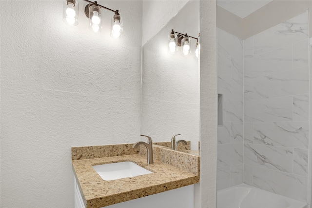 bathroom featuring vanity and tiled shower / bath combo