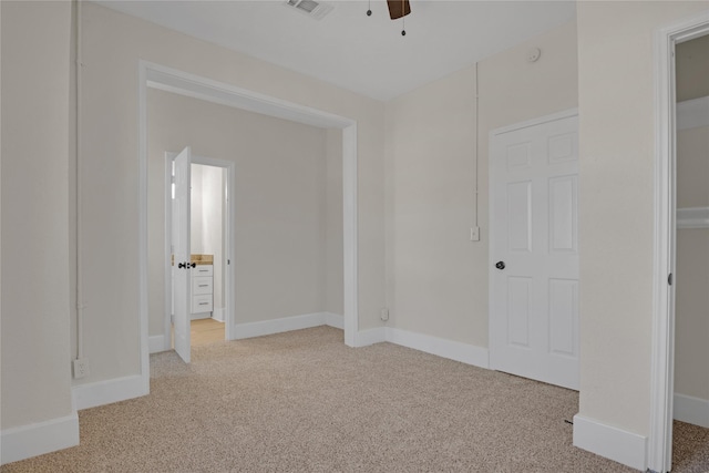 unfurnished bedroom with ceiling fan and light colored carpet