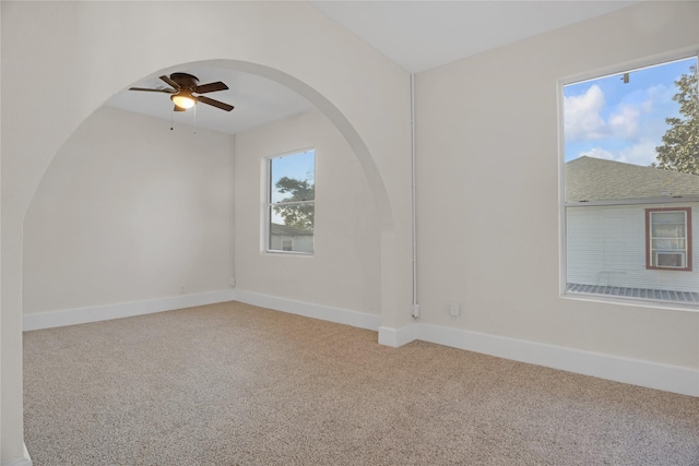 carpeted spare room featuring ceiling fan