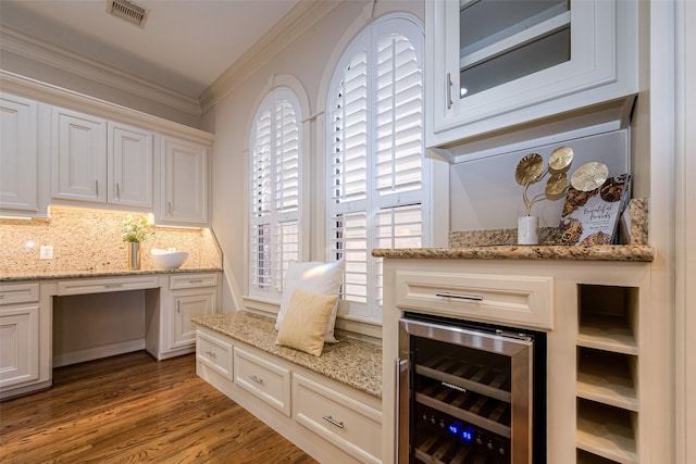 interior space with wine cooler, hardwood / wood-style floors, and ornamental molding