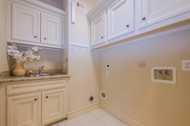 clothes washing area with hookup for an electric dryer, washer hookup, cabinets, gas dryer hookup, and sink