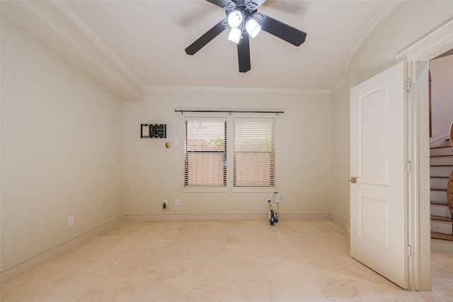 empty room with ceiling fan and crown molding