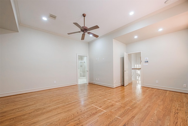 spare room featuring ceiling fan, ornamental molding, and light wood-type flooring