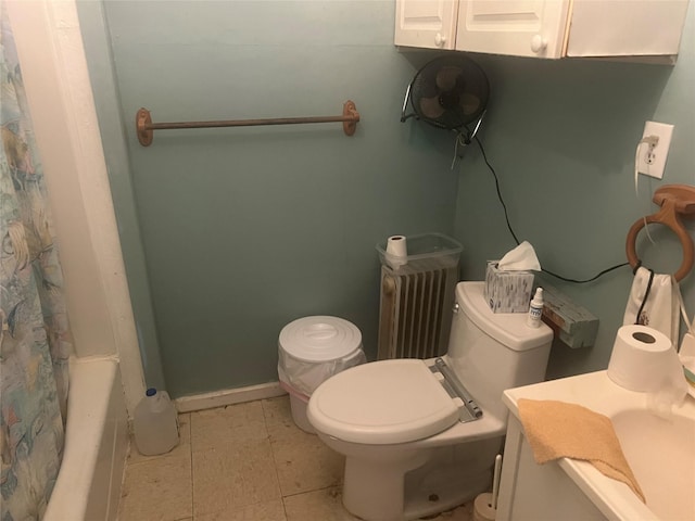 bathroom featuring curtained shower and toilet