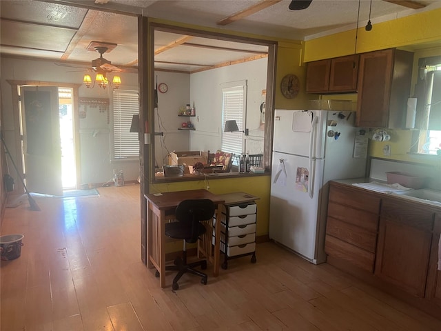 kitchen with ceiling fan, light hardwood / wood-style flooring, white fridge, and pendant lighting