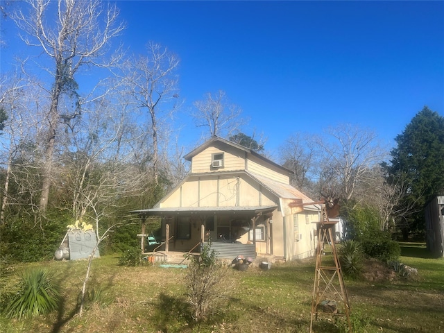 rear view of property featuring a porch