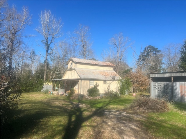 view of side of home featuring a yard