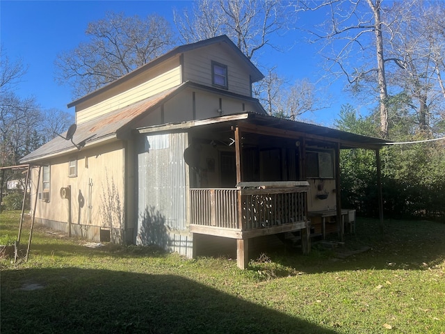 rear view of house with a yard