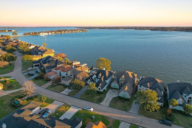 aerial view at dusk with a water view