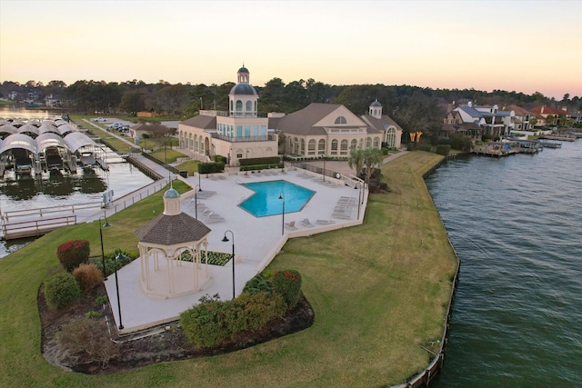 exterior space with a lawn and a water view