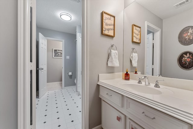 bathroom with vanity and a textured ceiling