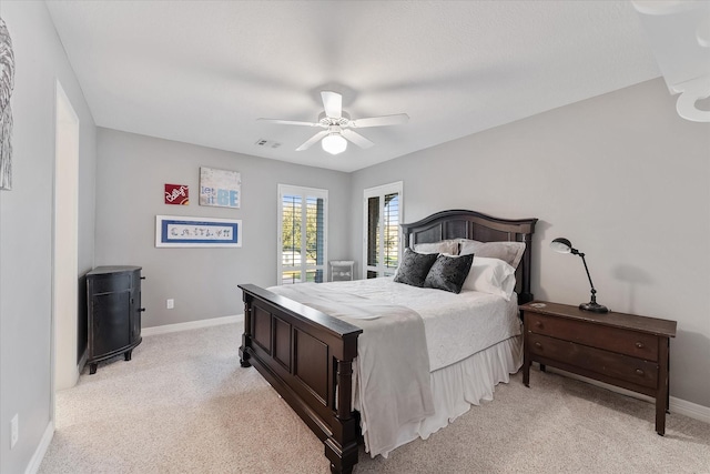 bedroom with ceiling fan and light carpet