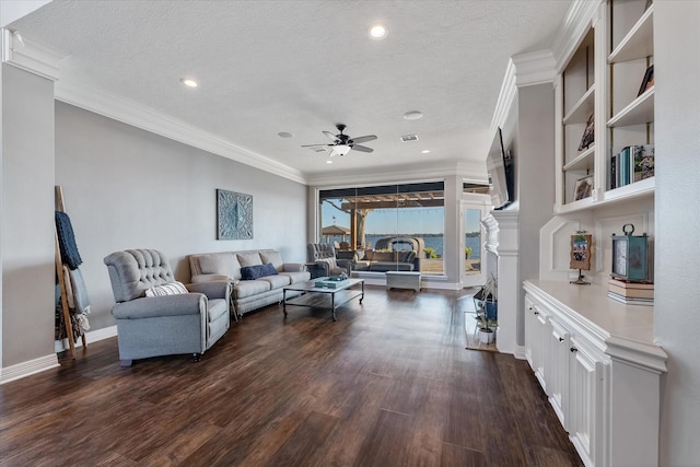 living room featuring ceiling fan, crown molding, a textured ceiling, and dark wood-type flooring