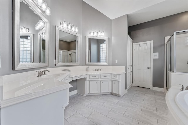 bathroom with tile patterned floors, vanity, and separate shower and tub