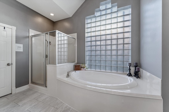 bathroom with independent shower and bath and vaulted ceiling