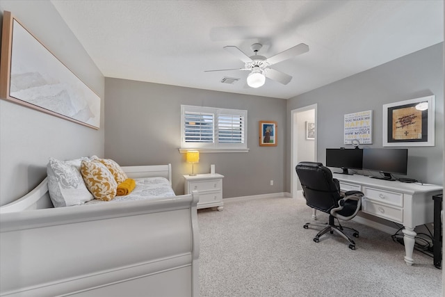 home office with ceiling fan and light carpet