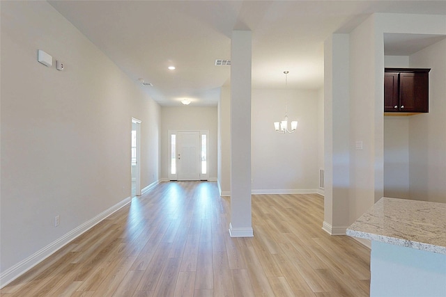 entryway featuring baseboards, recessed lighting, a notable chandelier, and light wood-style floors