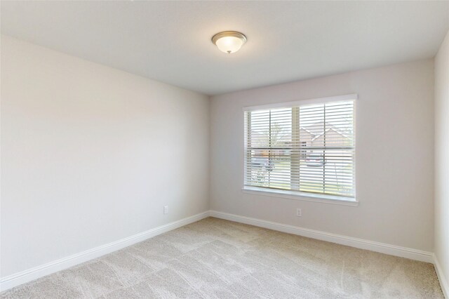 19818 Paros Island Dr, Hockley, TX 77447 - spare room featuring light carpet and baseboards