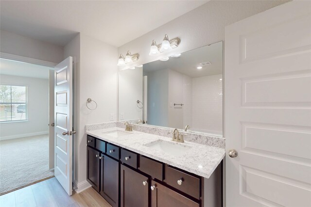 19818 Paros Island Dr, Hockley, TX 77447 - bathroom featuring double vanity and wood finished floors