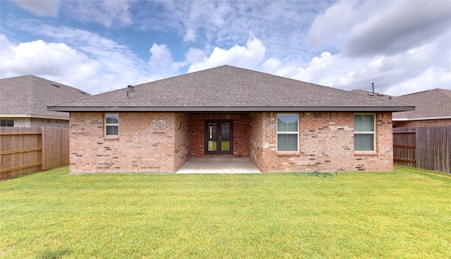 19818 Paros Island Dr, Hockley, TX 77447 - back of property with a shingled roof, brick siding, a fenced backyard, and a patio area