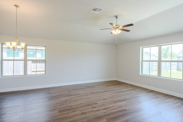 22207 Kastoria Dr, Hockley, TX 77447 - spare room with a chandelier, healthy amount of natural light, wood finished floors, a ceiling fan, and lofted ceiling