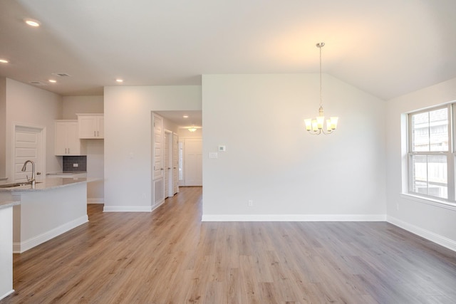 22207 Kastoria Dr, Hockley, TX 77447 - unfurnished dining area with light wood-style floors, a chandelier, vaulted ceiling, and recessed lighting