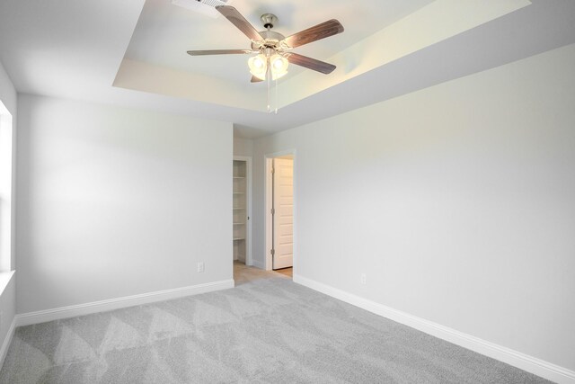 22207 Kastoria Dr, Hockley, TX 77447 - empty room featuring a raised ceiling, a ceiling fan, and carpet