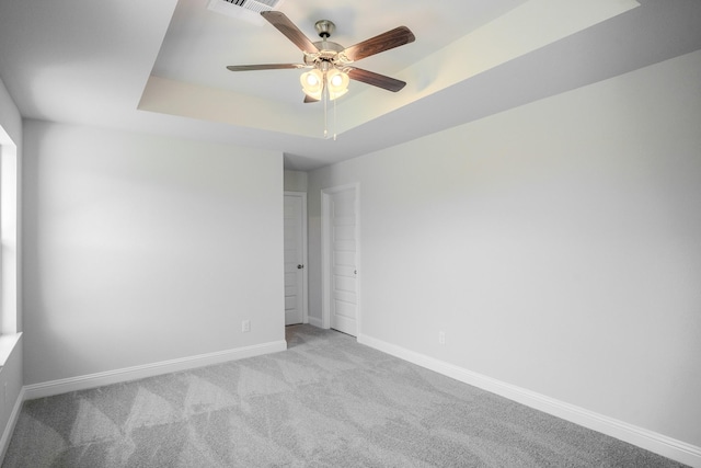 22207 Kastoria Dr, Hockley, TX 77447 - empty room with a raised ceiling, ceiling fan, and carpet floors