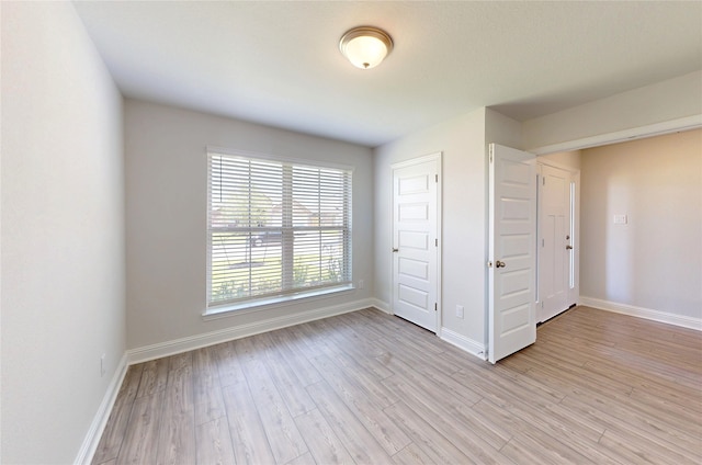 19814 Paros Island Dr, Hockley, TX 77447 - spare room with light wood-style flooring and baseboards